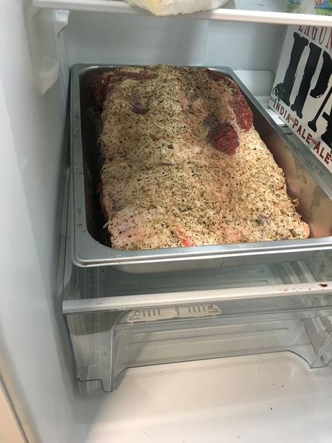 Brisket trimmed with rub in fridge serving pan